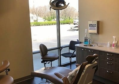 A dentist 's office with an open door to the window.